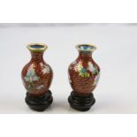 A pair of Cloisonne vases and stands.