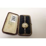 18ct yellow gold cased ladies wristwatch, champagne dial with black Arabic numerals and poker