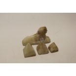Carved soapstone figure of a sphinx together with three carved soapstone pyramids (4)