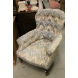 Late 19th / Early 20th century Button Back Armchair with Floral Upholstery and raised on turned