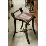 Late 19th / Early 20th century Mahogany Stool, the shaped seat with turned back rail and brass