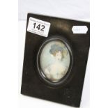 19th century oval portrait miniature on ivory depicting a woman in evening dress with hat in