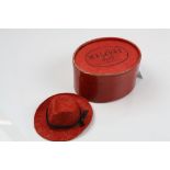 Boxed miniature Mallory hat, trillby style, red felt with black ribbon, dimensions approximately 3cm