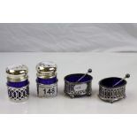 A pair of Mappin and Webb silver plated salt and pepper cruets raised on four ball feet with blue