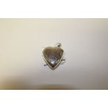 A silver heart shaped vesta case.