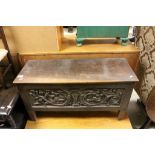 Small Antique Oak Coffer with heavily carved panels to front and two sides, 84cms long, 46cms high