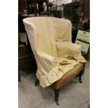 George III Style Barrel Wing Back Armchair raised on mahogany tapering legs and brass castors