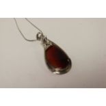 A silver and large pear shaped agate necklace.
