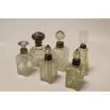 Six silver and white metal topped glass scent bottles, with stoppers, assorted shapes and sizes (6)