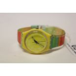 Retro yellow faced swatch watch.