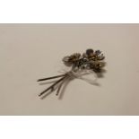 Silver floral spray brooch, three rotating flower heads with gilt centres, simple loop and pin