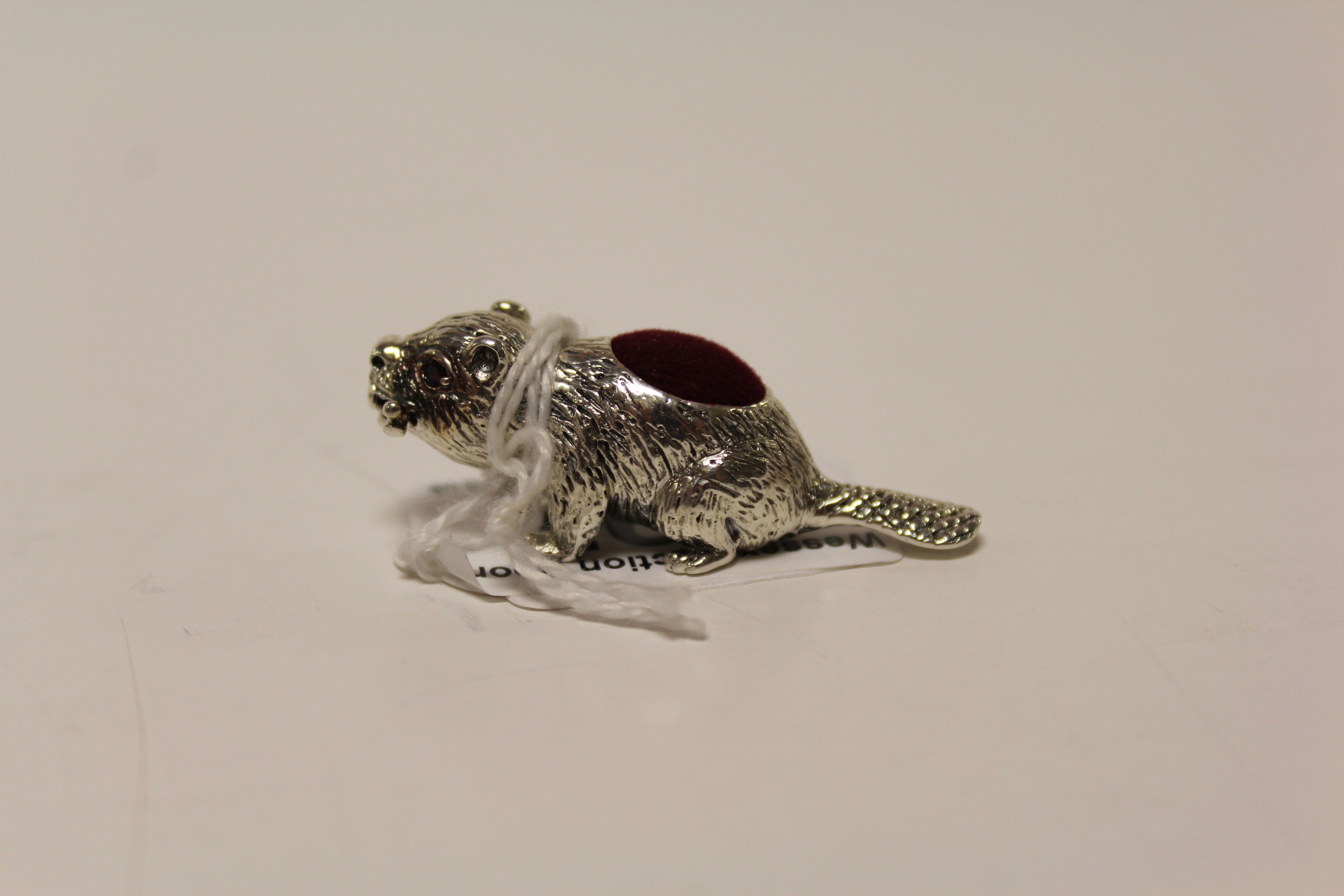 A silver pincushion in the form of a beaver with ruby eyes. - Image 2 of 3