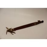 African tribal style decorative short sword with leather sheath and tassels, length approximately