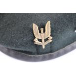 A green beret with and SAS Cap Badge.