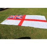 A very large Royal Navy white ensign flag reputedly removed from the H.M.S Ark Royal, the flag