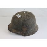 WW2 German helmet in relic condition , some original paint and decals still present.