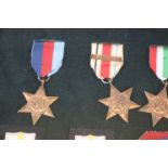 A framed collection of British WW2 Medals to include : The 1939-1945 British War Medal, The