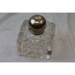 A large silver top cut glass inkwell, hallmarked for London 1899