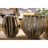 Two Tribal drums, one made of Wood, the other White metal