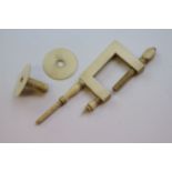 A 19th century ivory and bone sewing clamp of rectangular form, length approximately 10.5cm