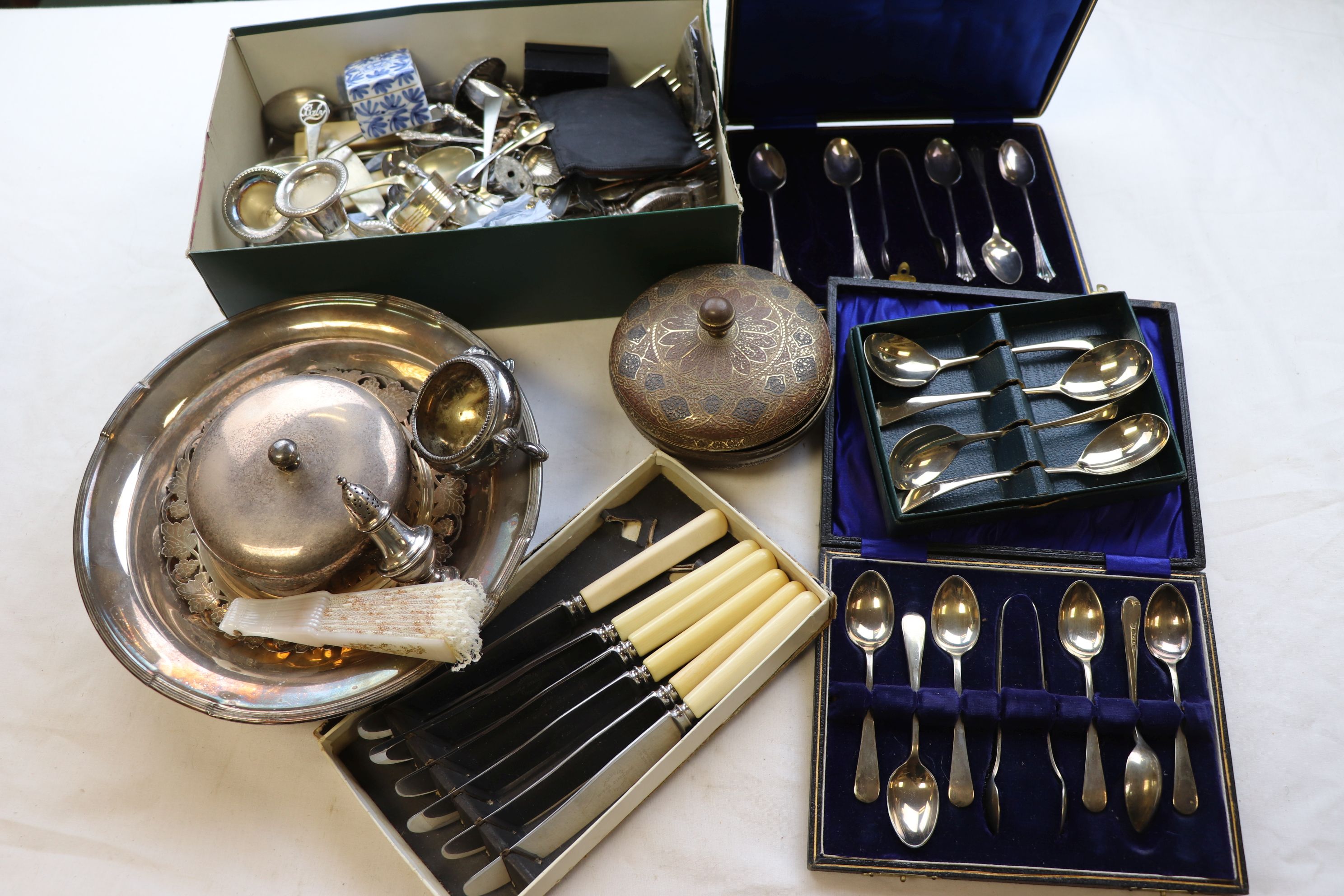 Assorted silver plate to include a pair of dwarf candlesticks, napkin ring, flatware, a compact,