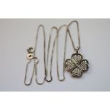 A silver lucky four leaf clover pendant necklace on silver chain