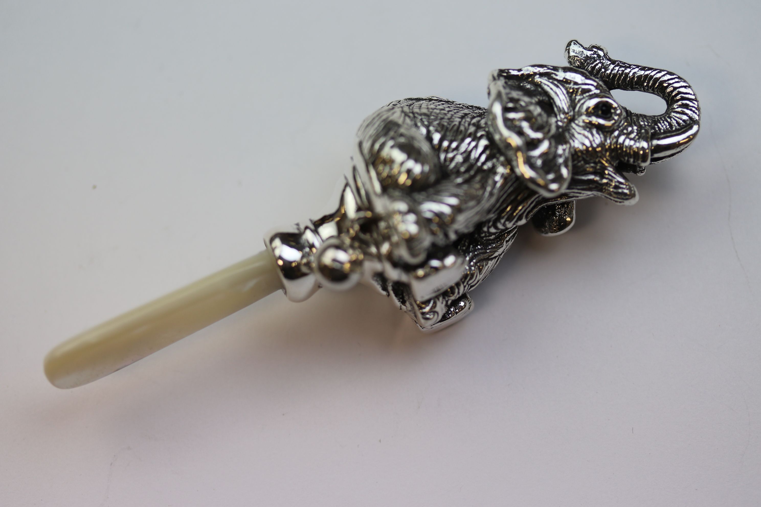 An antique style silver baby's rattle in the form of an elephant