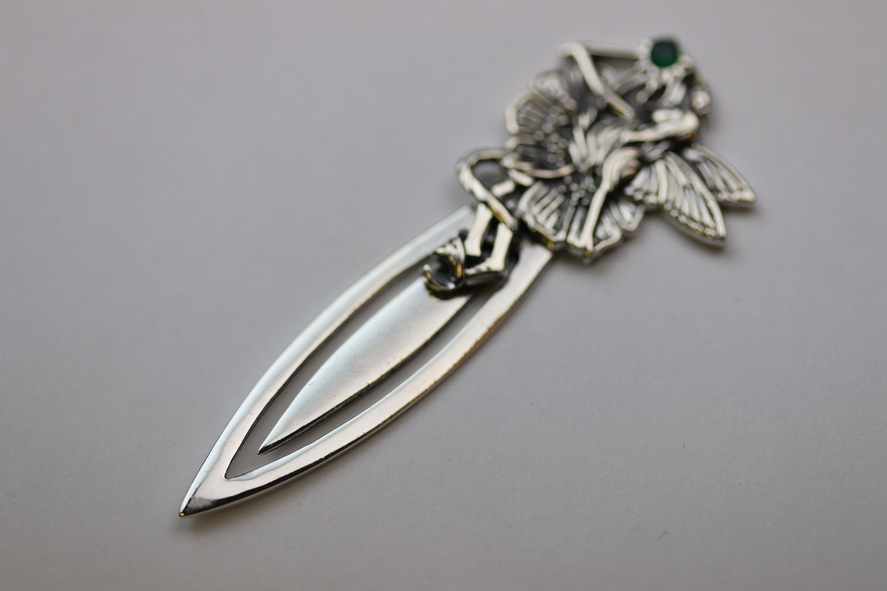 A silver bookmark with fairy finial