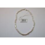 A mother of pearl necklace with silver clasp