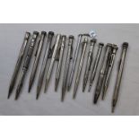 Collection of white metal propelling pencils including blue paste inset propelling pencil engraved