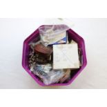 A tub of vintage buttons, costume jewellery, tie clips, cufflinks and dress studs to include