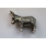 A silver model of a donkey with a glass eye