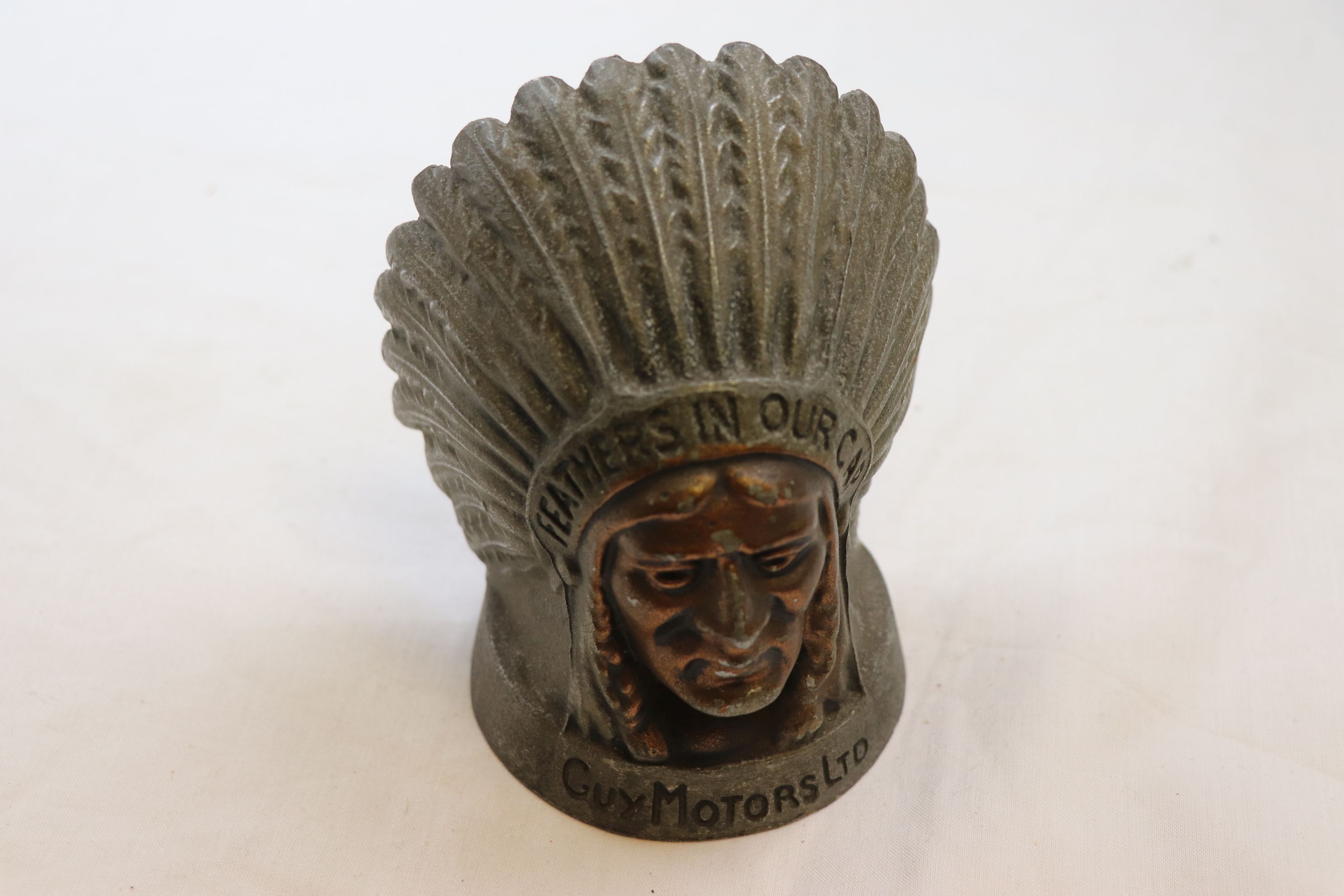 Guy Motors Ltd car mascot depicting Indian chief with the words Fathers in Our Cap to the headdress,