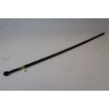 Black finished vintage walking stick with a carved Oriental style wooden handle