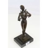 A bronze art deco style figure of a dominatrix on stepped marble base