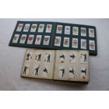 Two cigarette card albums containing Wills cigarette cards to include Semaphore flags, tribal