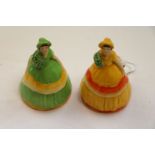 A pair of circa 1930s novelty porcelain napkin rings in the form of Victorian ladies holding