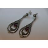 A pair of silver CZ and simulated ruby drop earrings in the art deco style