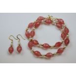 A faceted rose quartz necklace and matching earrings