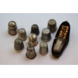 Eight silver thimbles together with a Charles Horner Dorcas thimble size 8 and another cased