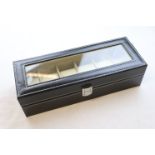 A six section watch box with glass lid