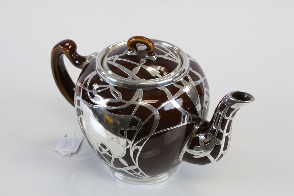 An Art Nouveau treacle glaze teapot with white metal overlay, the central flower motif with - Image 2 of 3