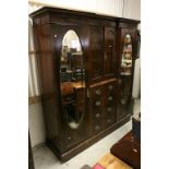 Edwardian Mahogany Inlaid Triple Compendium Wardrobe comprising central cupboard over a bank of