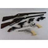 Collection of vintage toy guns to include a Daisy rifle and another similar rifle, five revolvers to