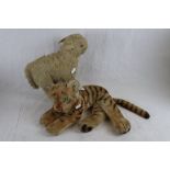 Two mid Century soft toys to include straw filled lamb and a laying tiger, both showing wear