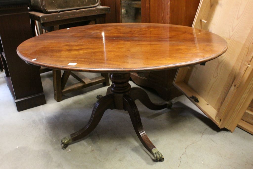 19th century Oval Tilt Top Loo / Centre Table raised on a turned column support and four reeded