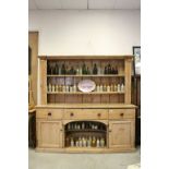 19th century Pine Dresser, the upper section with two shelves above three drawers and central pot