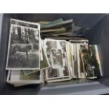 Over 1000 vintage topographical and other postcards with five empty postcard albums