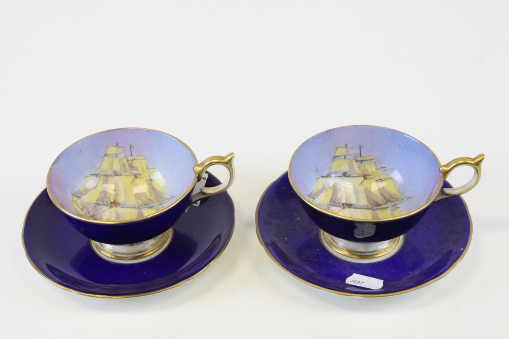Pair of Aynsley cabinet cups and saucers with hand painted bowls depicting Sailing ships