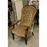 Victorian Mahogany Framed Gentleman's Button Back Armchair raised on turned legs and castors